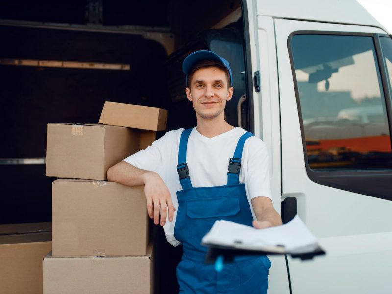 Deliveryman in uniform holding parcel, delivery Deliveryman in uniform holding parcel, delivery